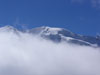 Il Piz Palù spunta fra le nubi.
